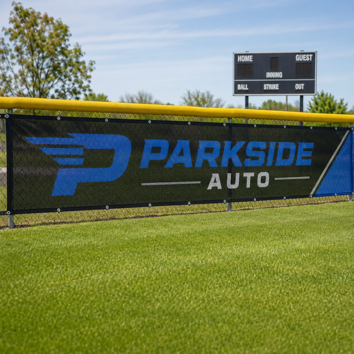 Custom sponsor mesh banner on a baseball field fence